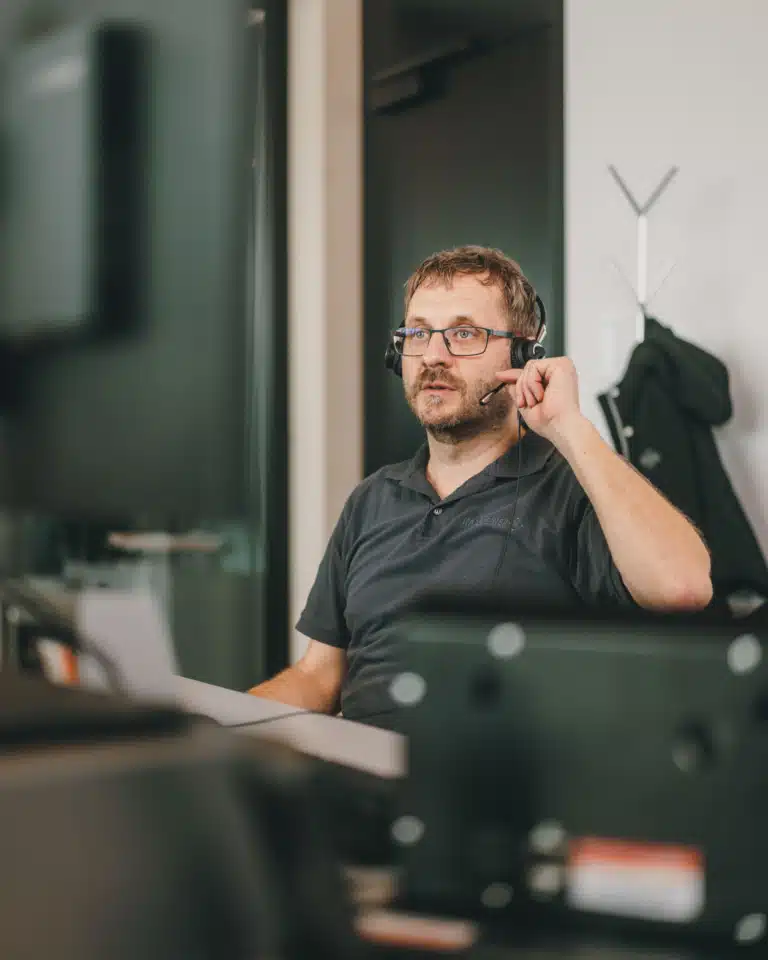 Symbolbild Abteilung Kundendienst & Ersatzteillager - Mann telefoniert mit Headset